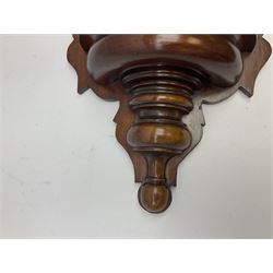 Mahogany wall bracket with circular mirror plate set against a shaped mahogany back with turned detail beneath a semi-circular well, H76cm