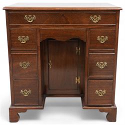 Georgian design mahogany kneehole desk, moulded rectangular top over single drawer, shaped frieze drawer and six short drawers, recessed kneehole with cupboard, on bracket feet