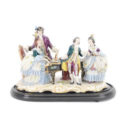 German lace figure group, modelled as a piano recital, the female figures with lace skirts...