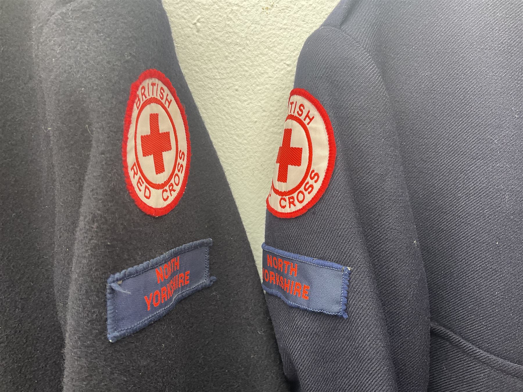 1950s British Red Cross North Yorkshire dress uniform comprising tunic, trousers, greatcoat and visor cap; bears manuscript label '1956 Ware'