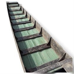 Large early 20th century plank-built wooden river punt, the long tapering hull with enclosed fore and aft decks, open green-painted ribbed interior, together with two paddles