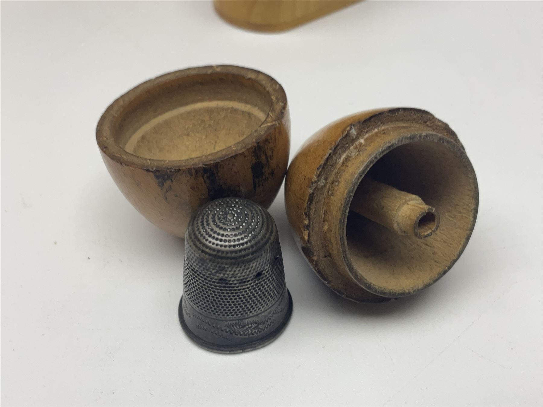 Collection of Mauchline ware relating to sewing, to include four ovoid shaped thimble cases, hinged lid thimble case and needle cases (12) 