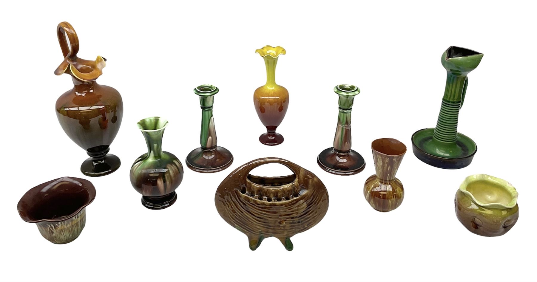 Linthorpe pottery vase with crimped rim and ovoid body, Linthorpe jug with high loop handle and crimped spout, a pair of candlesticks with a green, brown glaze and other similar pottery 
