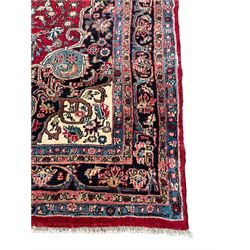 North West Persian Bidjar red ground carpet, shaped pole medallion surrounded by interlacing branches and stylised flower heads, five band border with repeating floral design