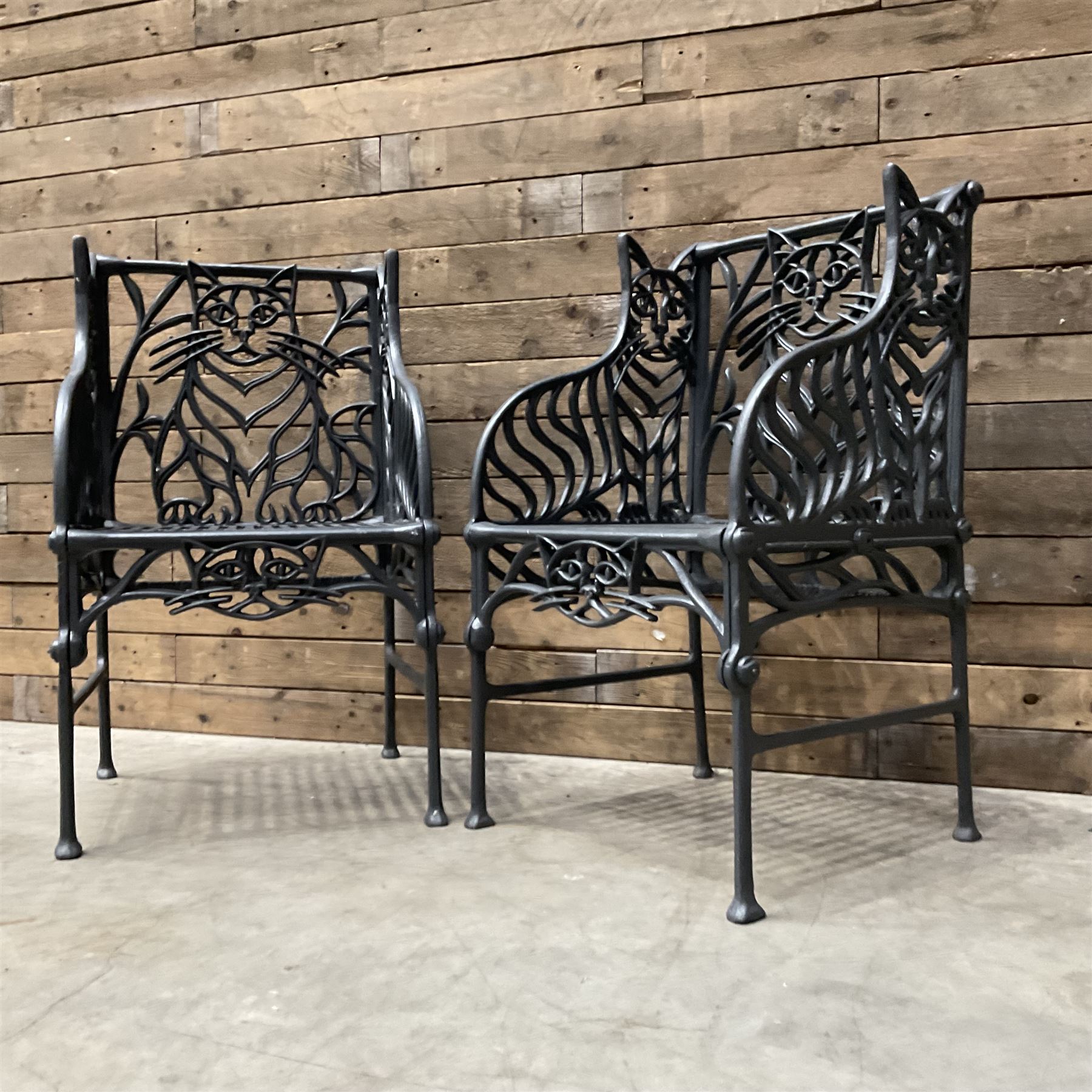 Richard Bawden (1936-2024): Pair of Cat design painted cast iron garden armchairs