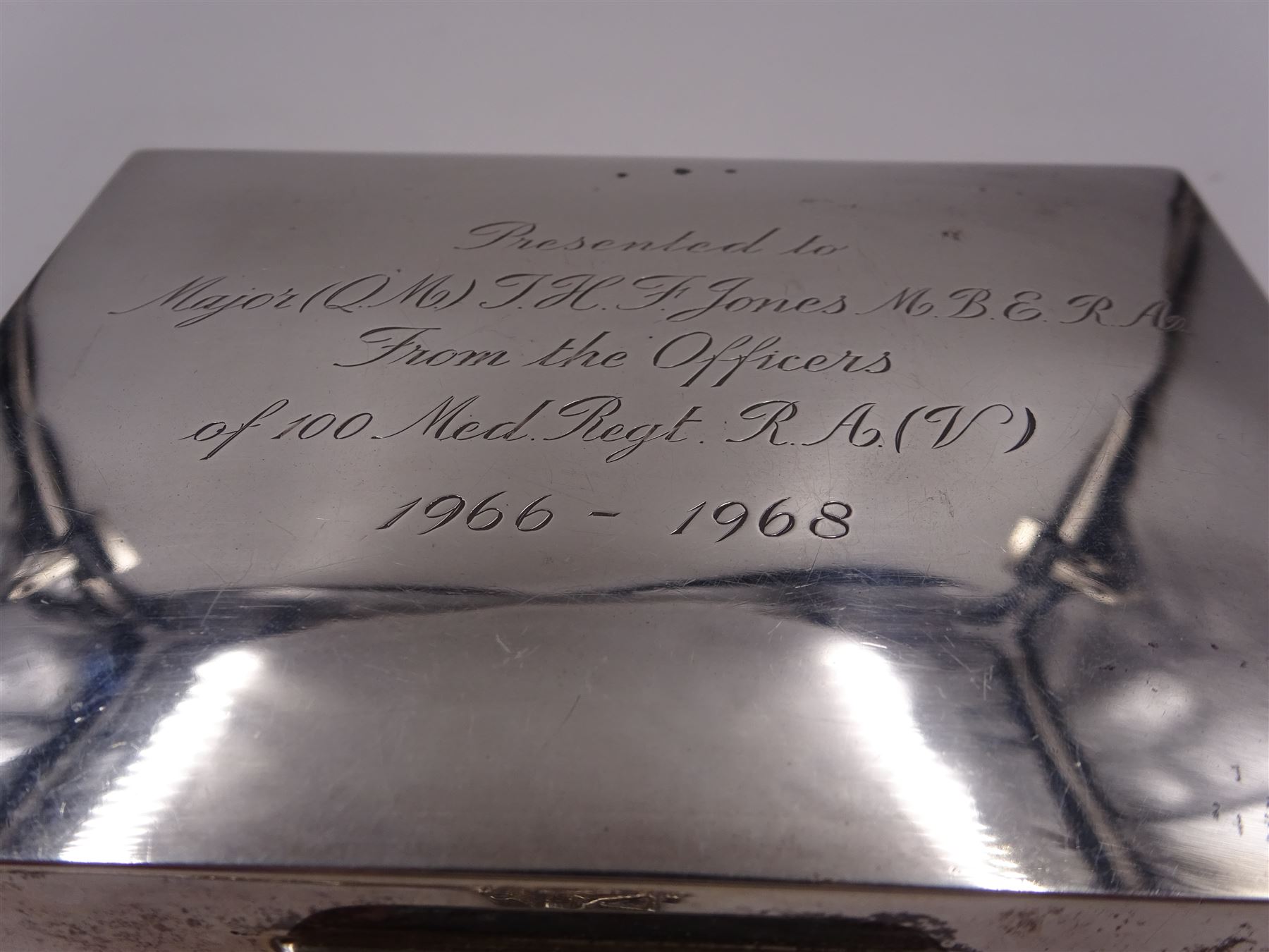 Modern silver mounted cigarette box, of plain rectangular form, with personal engraving to hinged cover, opening to reveal soft wood lined interior, H3.8cm, W21.5cm, hallmarked Padgett & Braham Ltd, London 1967, together with a silver cigarette case, with engraved C scroll decoration, hallmarked Joseph Gloster Ltd, Birmingham 1917 or 1942 and a silver souvenir spoon