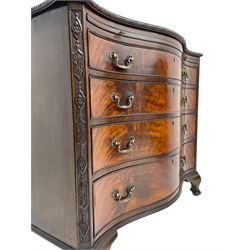 Chippendale design serpentine chest, shaped moulded top carved with repeating flower head motifs, fitted with brushing slide over four graduating drawers, pierced and foliate moulded handle plates with scrolled swan neck handles, canted upright corners carved with flower heads and strapwork, on canted ogee bracket feet