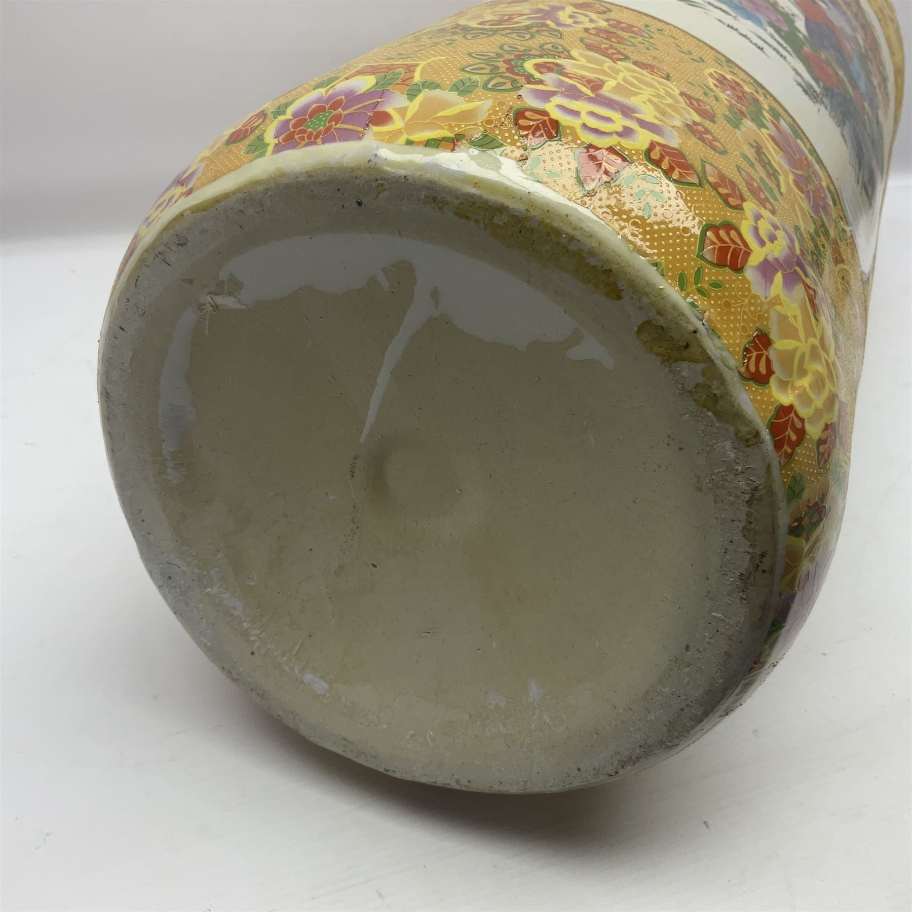 Modern Japanese ceramic umbrella stand, decorated with a figural panel on a yellow floral ground, H60cm