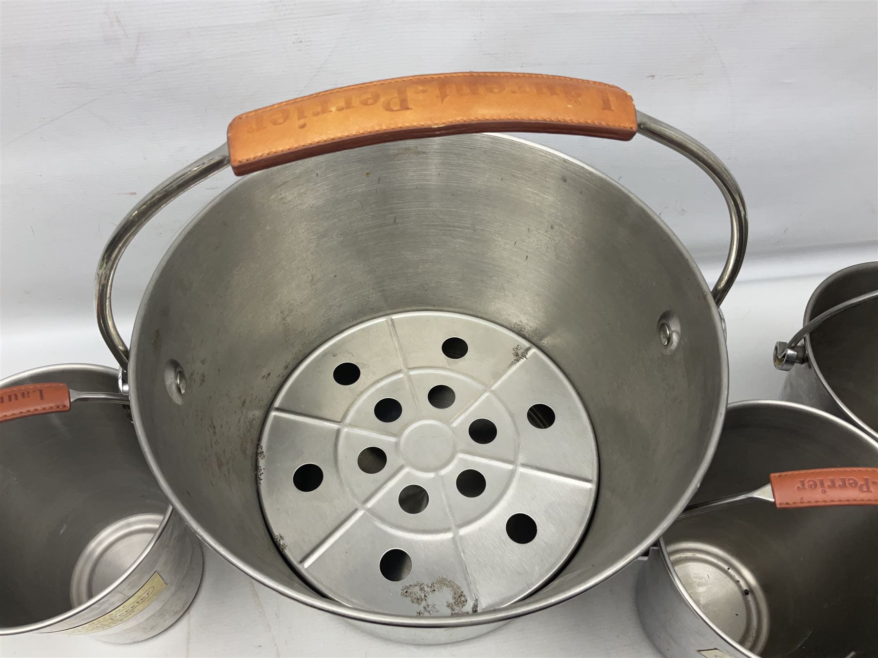Stainless steel Laurent-Perrier champagne bucket, with engraved brass plaque and grip to swing handle, together with three matching smaller, largest D38cm (4)