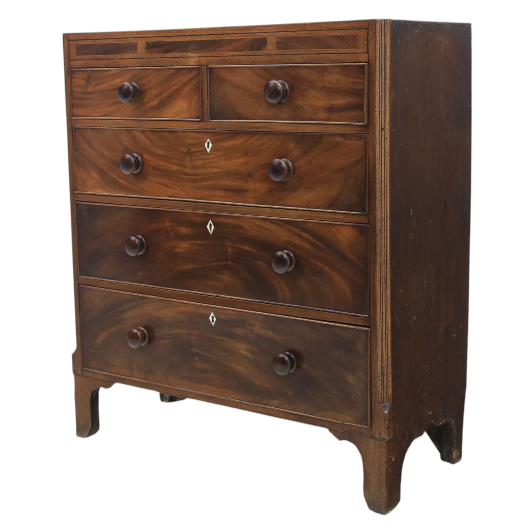 Early 19th century mahogany chest, straight front with canted corners, featuring inlaid detail above two short and three long drawers with flame veneered facias