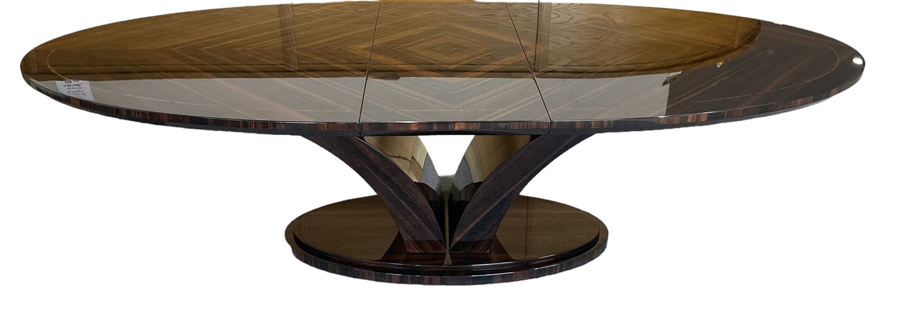 Giorgio Collection - Art Deco design macassar ebony 'Luna' extending dining table, oval top with quarter-matched veneer and stringing, raised on a curved V-shaped pedestal with oval base; with matching set of dining chairs, high macassar ebony back, the lower half and seat upholstered in black leather, on ebonised tapering supports, retailed by Harrods