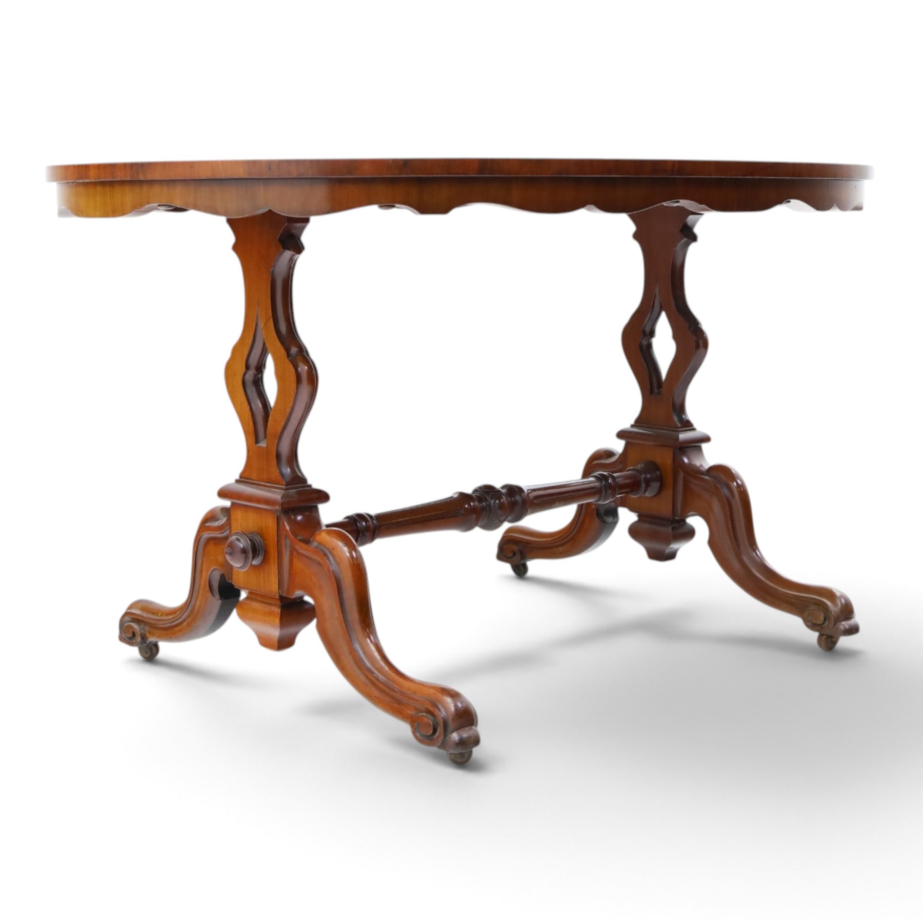 Victorian mahogany breakfast table, oval moulded top over a shaped frieze, on twin pierced lyre-form end supports with moulded scroll feet, united by a turned stretcher, on castors