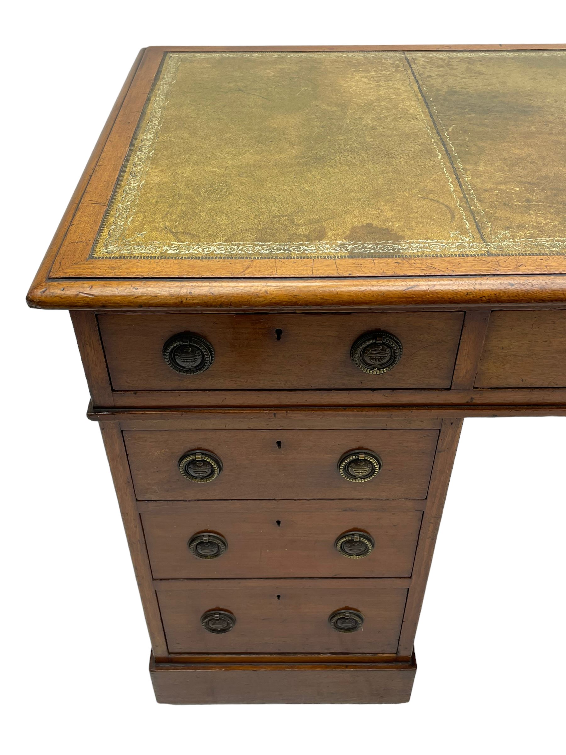 Howard & Sons. - 19th century walnut twin pedestal desk, moulded rectangular top with tooled leather inset, fitted with nine drawers with circular pressed brass handle plates decorated with urns, each drawer fitted with a 'Hobbs, London' lock, on plinth base, the upper right-hand drawer stamped 'Howard & Sons, Berners St.' and with paper label