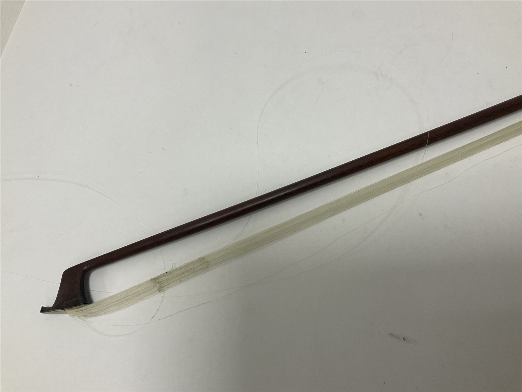 19th century wooden violin bow with a decorative mother of pearl inlay depicting flowers to the frog, with a bone adjuster screw