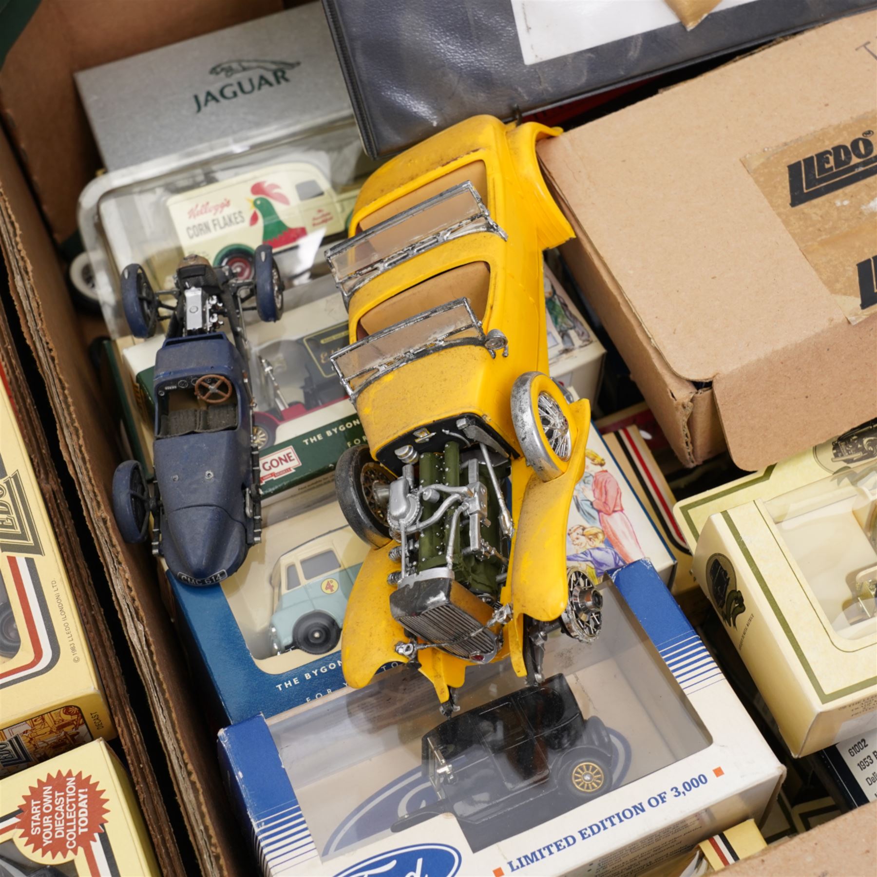 Approximately 80+ boxed die cast vehicles by Lledo, including Days Gone models, and a folder of collectors catalogues from 1989 onwards, contents in two boxes