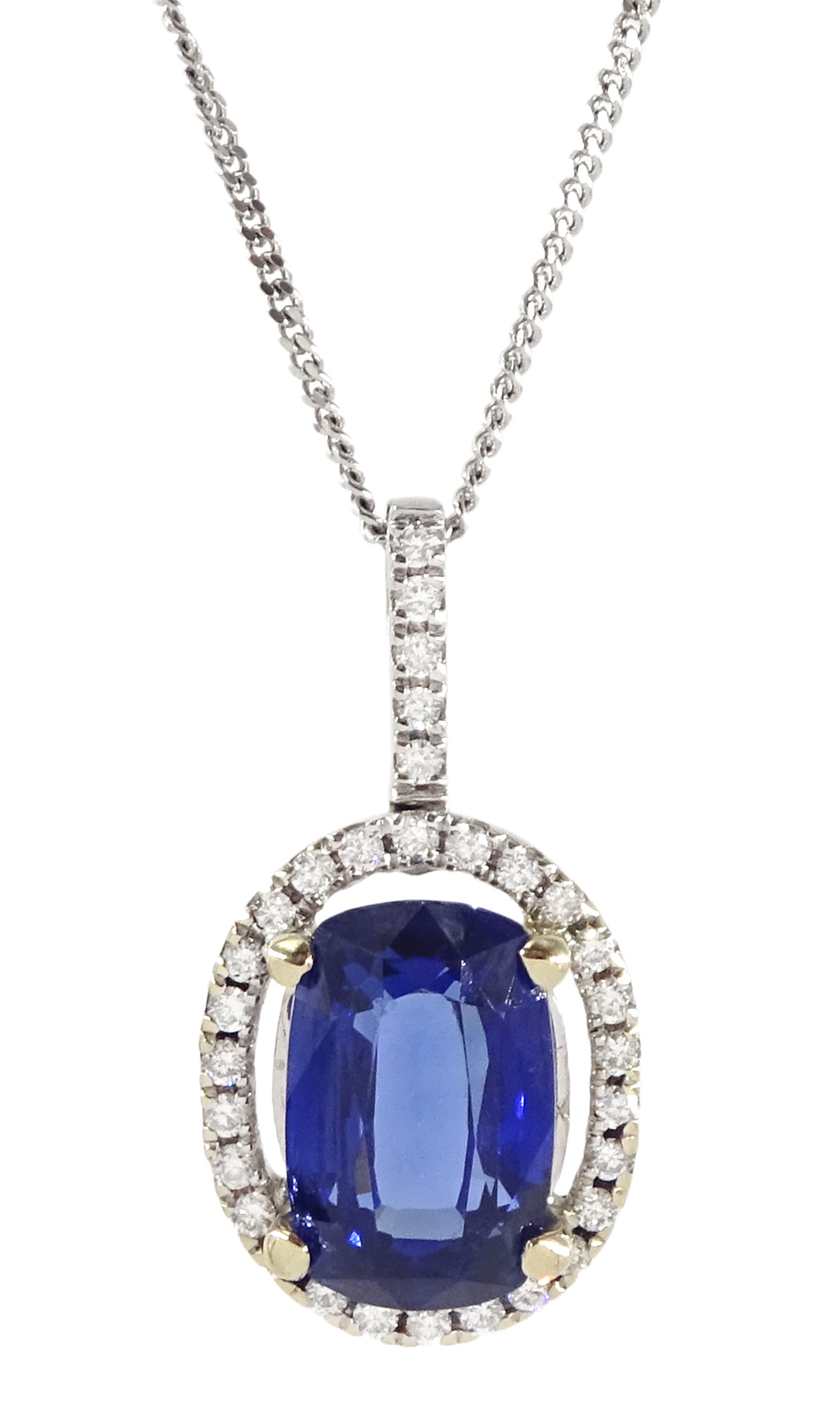18ct white gold sapphire and diamond halo pendant necklace, single cushion cut sapphire of approx 4.65 carat, with round brilliant cut diamond surround and bail, on fine flattened curb link chain necklace, both hallmarked, total diamond weight approx 0.35 carat