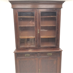  19th century mahogany bookcase on cupboard, two doors enclosing three shelves, two drawers above two cupboards on plinth base, W128cm, H211cm, D43cm  
