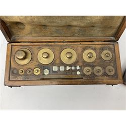 19th century cased set of Chemists' weights and tweezers and a set of brass postal scales on a footed base, with a graduated set of weights