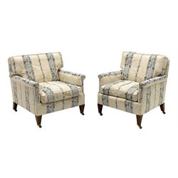 20th century hardwood framed three piece lounge suite consisting of two seat settee (W156cm, D82cm) and pair matching armchairs (W72cm), exposed mahogany feet with brass castors, upholstered in cream ground and blue Regency stripe floral patterned fabric