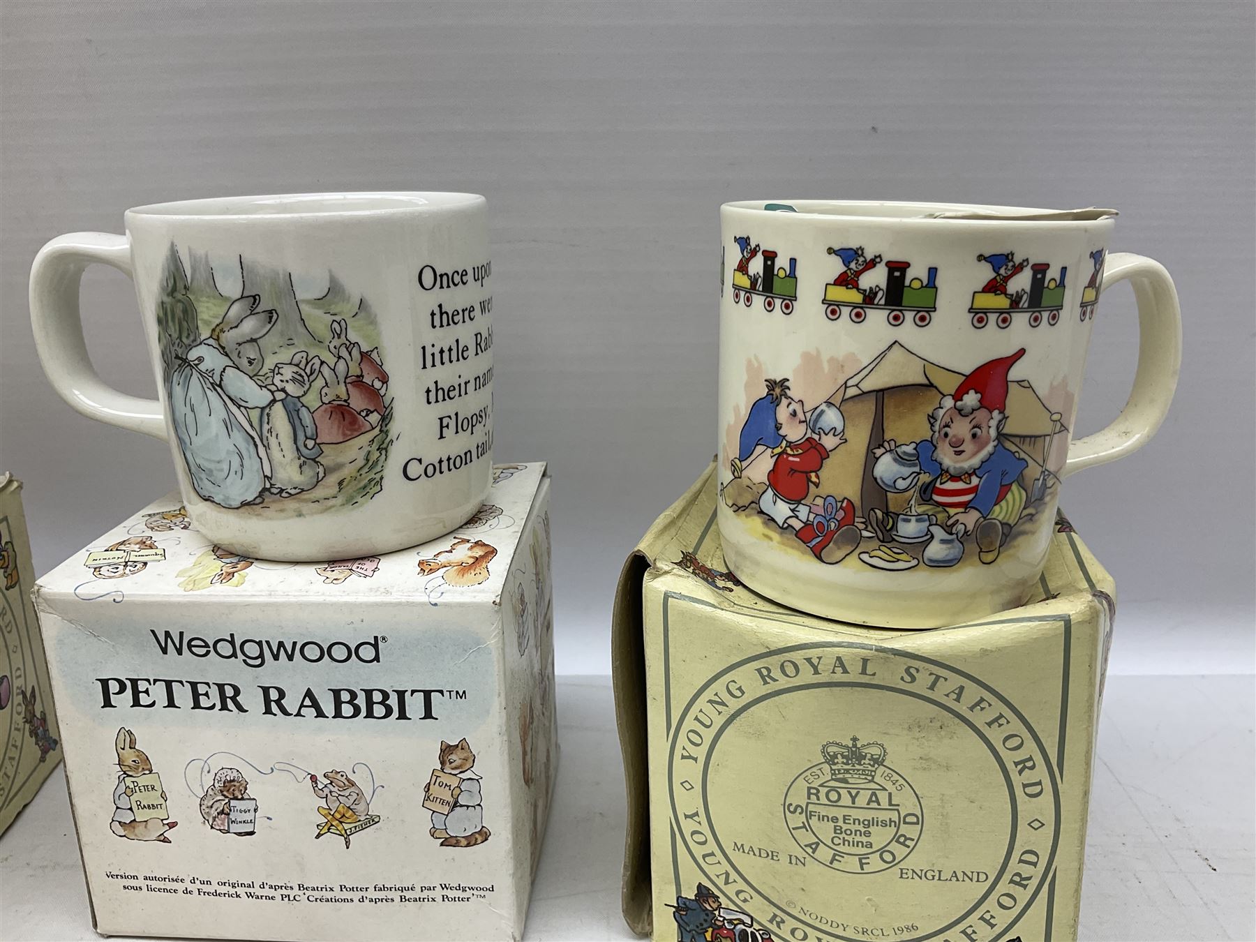 Royal Doulton Bunnykins nursery set in box and two cups, together with two Wedgwood Peter Rabbit mugs and Royal Staffordshire Noddy money box and cup (7)