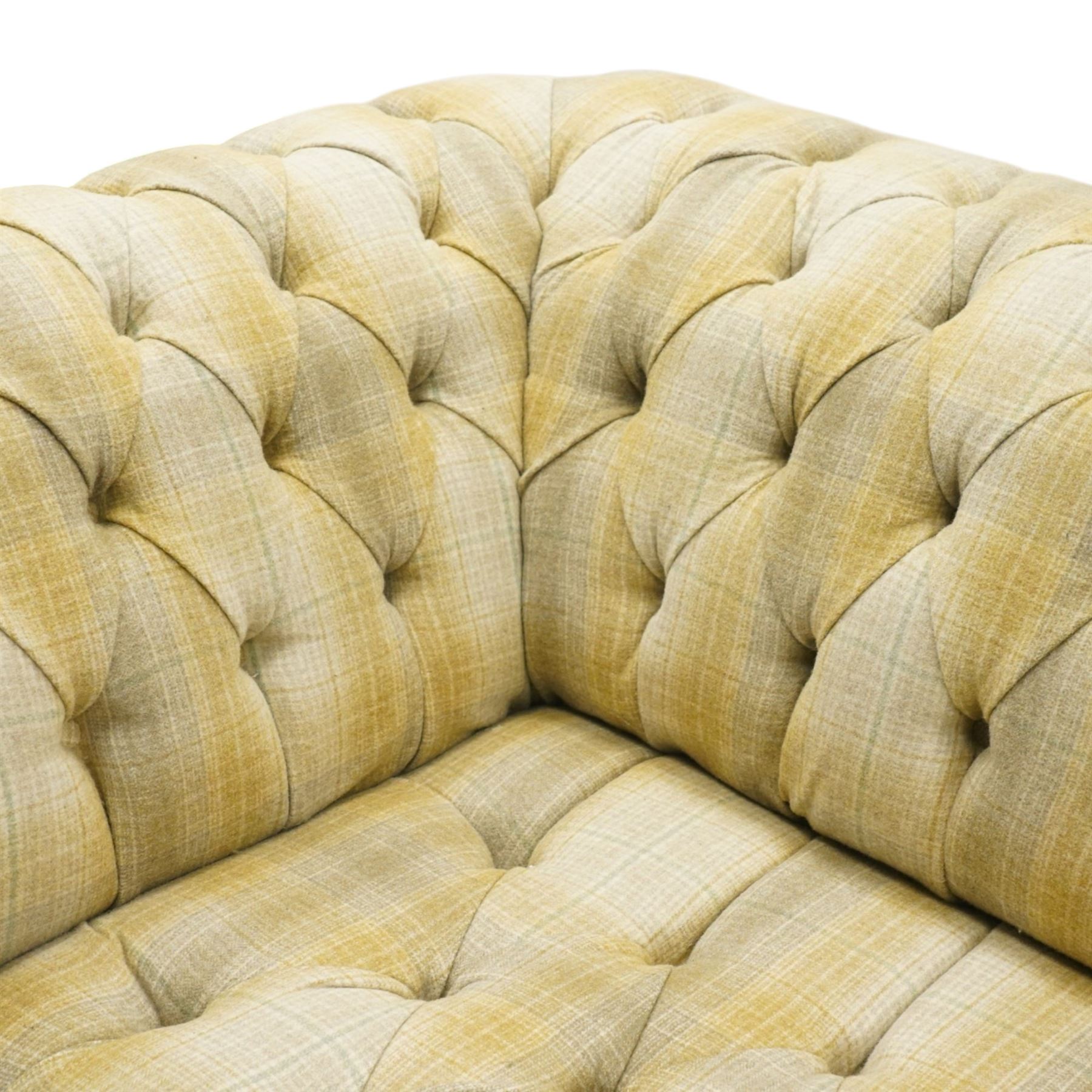 Late 20th century Chesterfield style two seat sofa, upholstered in muted green and yellow tartan fabric with buttoned back, arms and seat, on turned front supports with brass castors