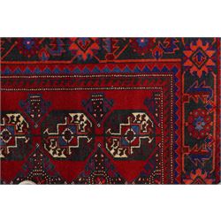 North East Persian Balochi hand-knotted runner, crimson field decorated with three vertical columns of repeating octagonal guls, each enclosing angular geometric motifs in deep indigo, ivory, and soft brown tones, guls linked by stepped diamond and cruciform devices, main border of stylized geometric floral motifs and angular vines, flanked by multiple guard borders, with cotton fringe ends 