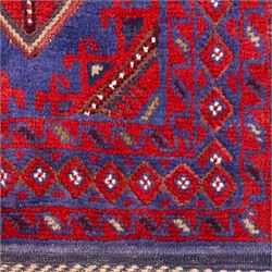 Afghan Meshwani runner, hand-knotted wool pile, indigo ground decorated with a vertical series of angular diamond medallions in tones of madder red, dark blue, framed by geometric borders with flatwoven kilim ends with fringe 