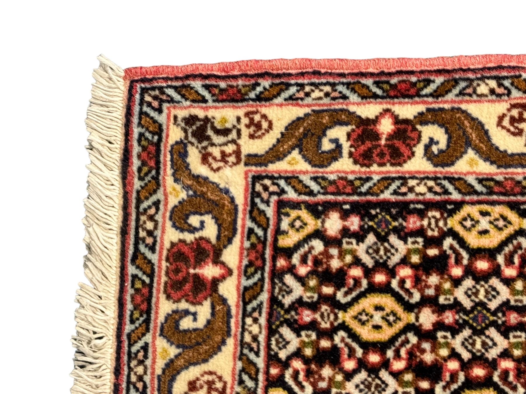 Small Persian Bidjar rug, the field decorated with floral Herati motifs, within floral design borders and guard stipes 