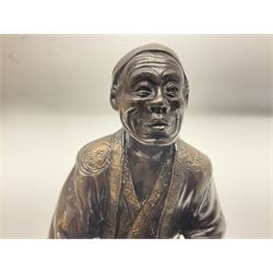 Oriental bronze figure of a gentleman, modelled seated upon barrel with a pipe in one hand and a flask in the other, H21cm