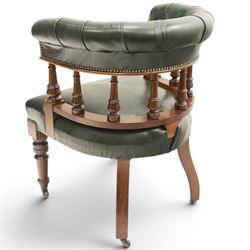 Late Victorian mahogany framed Captains tub desk chair, the green leather upholstered cresting rail over turned spindle supports over a sprung seat, raised on front turned supports terminating to ceramic castors