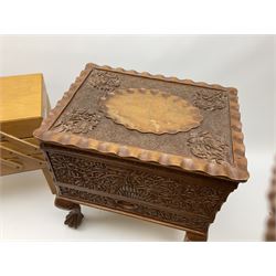 Two sewing boxes, the first with carved floral decoration, upon four claw and ball feet, the second, a concertina example, each with various sewing related contents.  