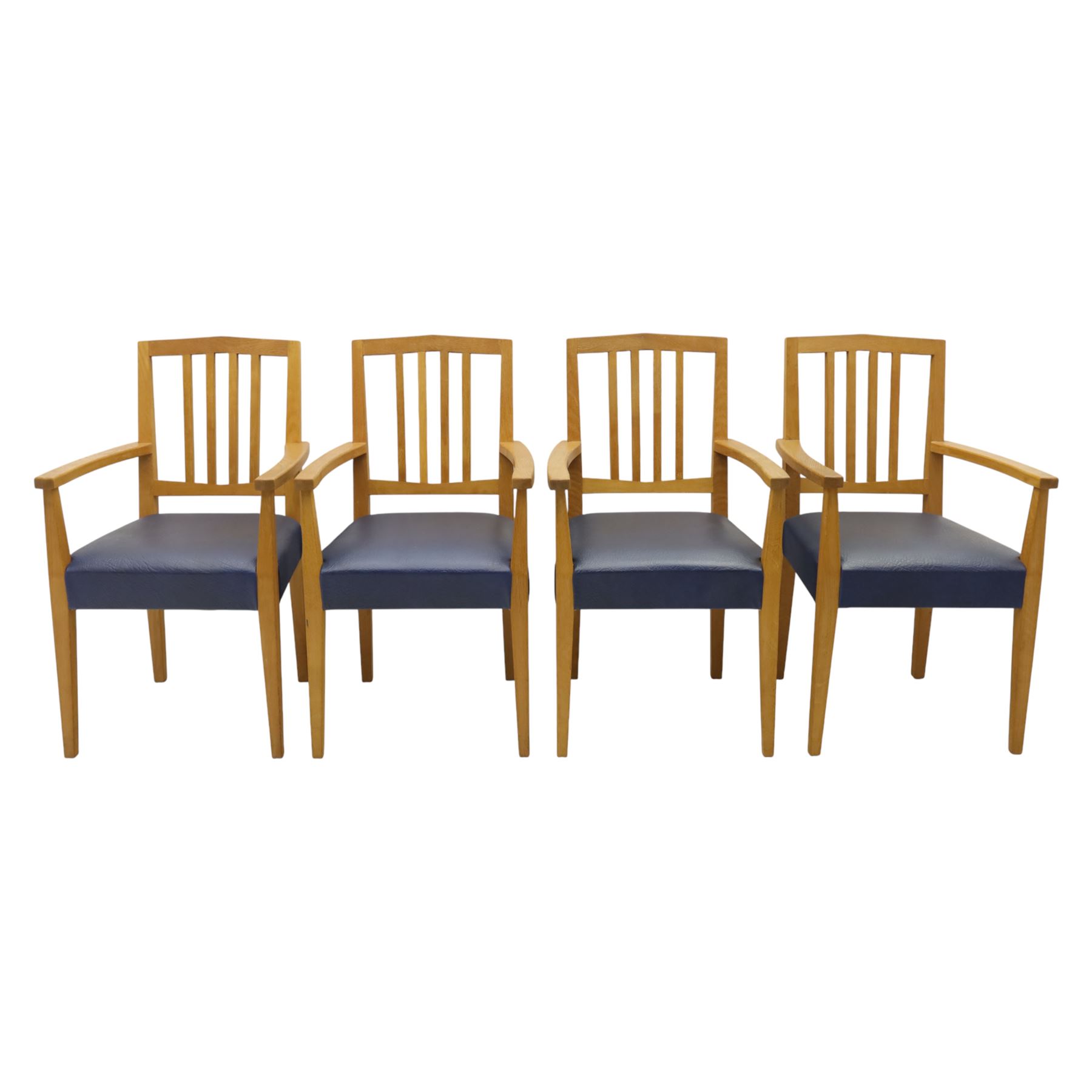 Modern twelve oak dining chairs including one 'Chairmans' chair, solid oak construction, slatted back and arm rests, blue leatherette padded seat, on tapered square supports 