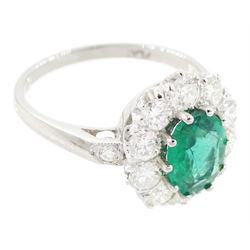 Platinum emerald and diamond cluster ring, single oval cut emerald of approx 0.90 carat, surrounded by ten round brilliant cut diamonds, and milgrain set diamond shoulders, stamped Plat, total diamond weight approx 1.00 carat