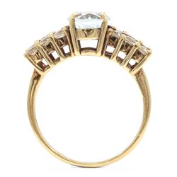 9ct gold aquamarine and blue topaz ring, single oval cut aquamarine, with two rows of round cut topaz's set either side, hallmarked