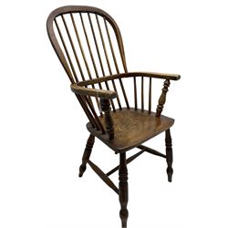 Early 19th century elm Windsor chair, high hoop and stick back over shaped saddle seat, raised on ring turned supports united by H-stretcher