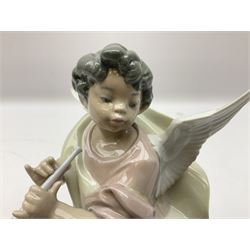 Two Lladro figures, comprising Carefree Angel with Flute no 1463, year issued 1985 year retired 1988, and Angel with Clarinet no 5494, both with original boxes
