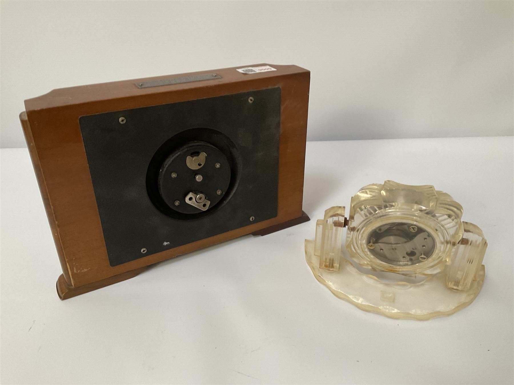 Two Art Deco style mantel clocks comprising a Smith’s 8 Day wooden clock and a clear geometric design clock 
