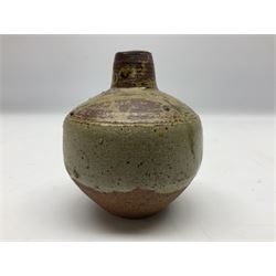 Janet Leach (American, 1918-1997) for Leach Pottery; speckled studio pottery vase of shouldered ovoid form with speckled brown decoration and trailing green and brown glaze upon beige and brown ground, with impressed J.L. monogram and Leach Pottery mark beneath, together with a Jeremy Leach blue speckled lidded circular dish with loop handle, impressed J.L, tallest H11cm