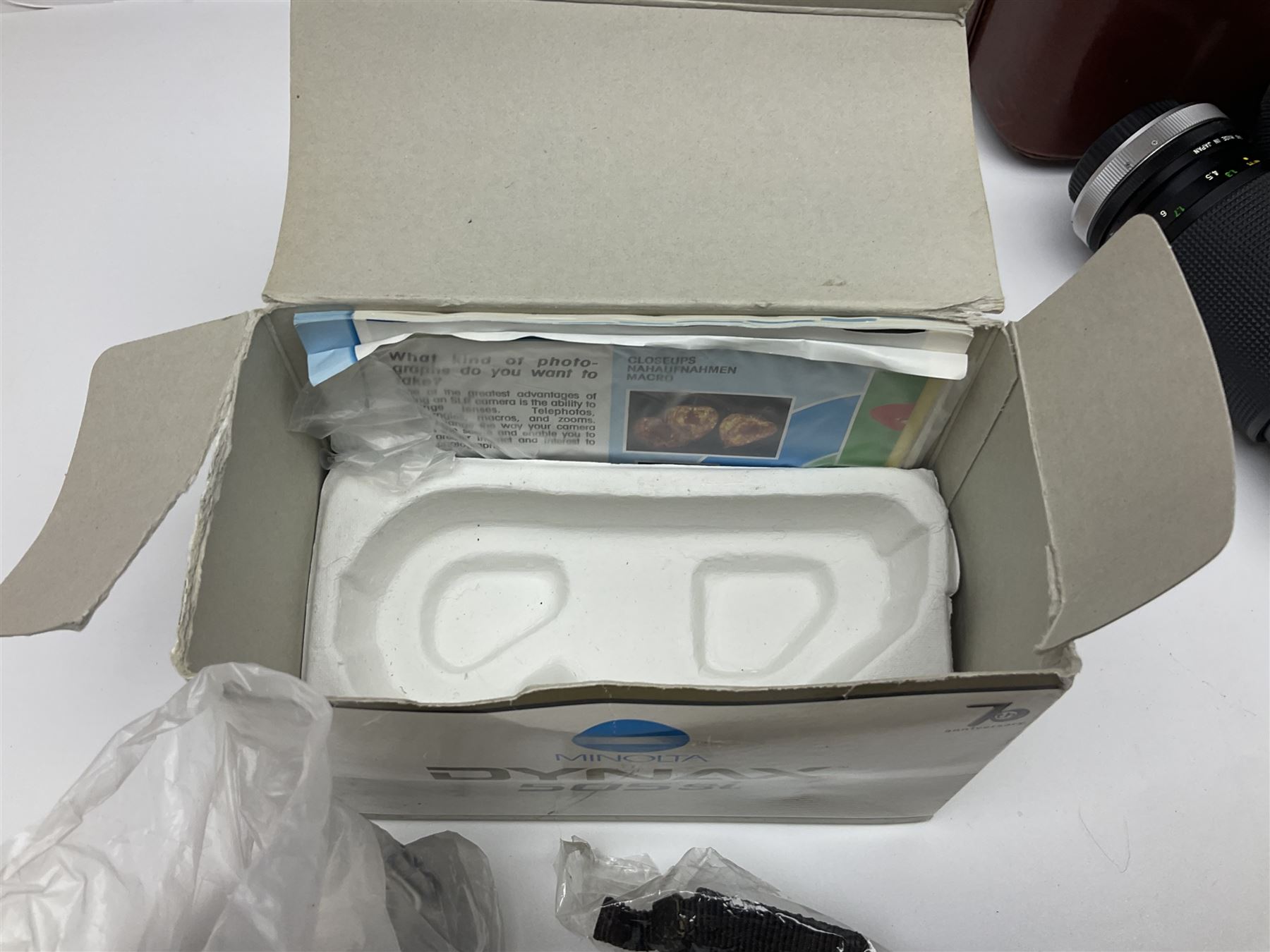 Four Minolta camera bodies, to include Dynax 500si, serial no. 94812651 with 'Signa Zoom 1;3.5-4.5 f=28-70mm' lens, Maxxum 300si, serial no. 97821665, with 'Tamron AF 80-210mm' lens and Dynax 300si, serial no 01603265'  with Minolta AF Power Zoom 35-80mm 1;4' lens, etc, together with Pantax MV1 camera bodies and other camera equipment 