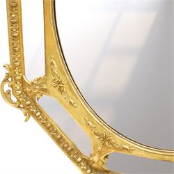 Late 19th century French giltwood and gesso wall hanging cushion mirror, the pierced foliate rocaille pediment extending acanthi C-scrolls and trailing bellflowers, over a floral garland and cartouche moulded rails, the central oval bevelled plate surrounded by further bevelled cushion mirrors, with out-scrolling pierced motifs flanking the floral egg-and-dart moulded outer edge, over a pierced foliate cartouche terminal