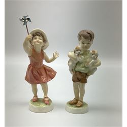 Royal Worcester 'Three's Company' figure, Royal Worcester 'Let's run', Royal Doulton Rupert Bear, Crown Staffordshire figure of girl with a dog, a Victorian fairing, continental figure of a boy and girl and four Hummel figures.   
