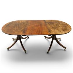 George III mahogany twin pedestal extending dining table, the twin D-ends with additional ...