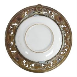 Pair of late 19th century English porcelain hand painted portrait plaques, each of circular form, set within a brass foliate and shell pierced surround, the first example depicting William Ewart Gladstone, the second Benjamin Disraeli, overall D19.5cm