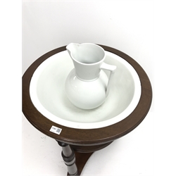  Early 19th century circular mahogany two tier washstand with ceramic bowl and jug, three turned supports, on brass and ceramic castors, D61cm, H80cm  
