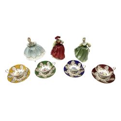 Four Paragon tea cups and saucers with gilt and floral decoration in various colours, together with three Royal Doulton figures, First Lady HN2193, First Dance HN2803, Buttercup HN2399 