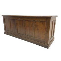 Illingworth Ingham and Co. School Furnishers (Leeds c1900) - early 20th century oak rostrum or headmaster's desk, rectangular top, the front and sides panelled with open reverse, on plinth base