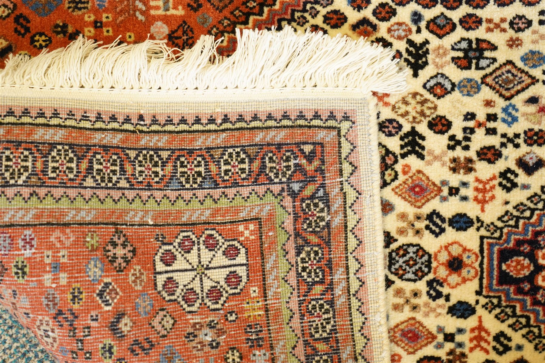 Persian design wool rug, 'Tarange-Lachak' medallion and corner design on a white and pink field framed by pink borders 