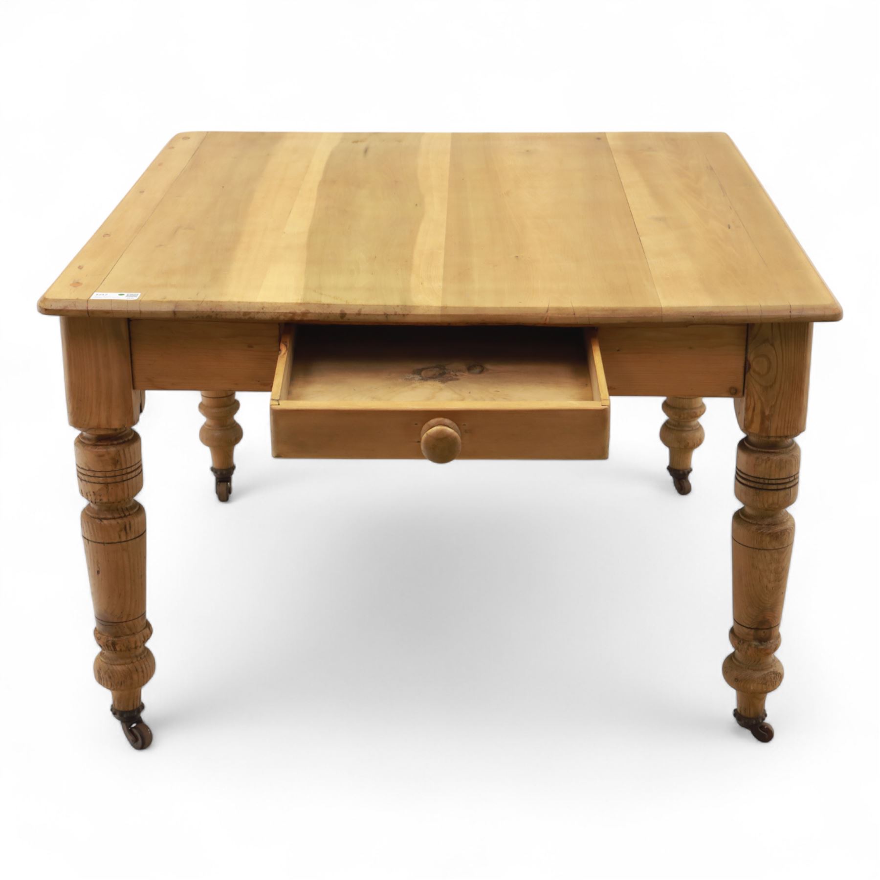 Contemporary pine kitchen table, rectangular top with moulded edge, fitted with single drawer, raised on turned supports with ceramic castors
