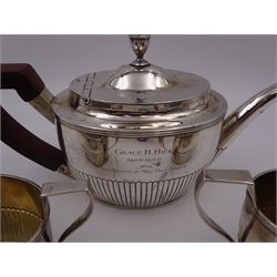 1930s American silver three piece batchelors tea service, comprising teapot, twin handled open sucrier and milk jug, each of part fluted oval form, the teapot with personal engraving to body, wood effect handle and silver urn shaped finial, stamped sterling with maker's mark for Gorham, teapot H13cm