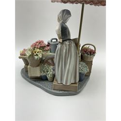 A Lladro figure, Flowers of the Seasons, designed by José Puche, model number 1454, H27cm 